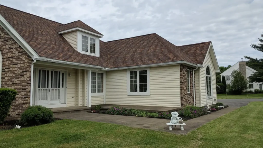 Siding installation in progress on a Utica NY home by Cobblestone Construction